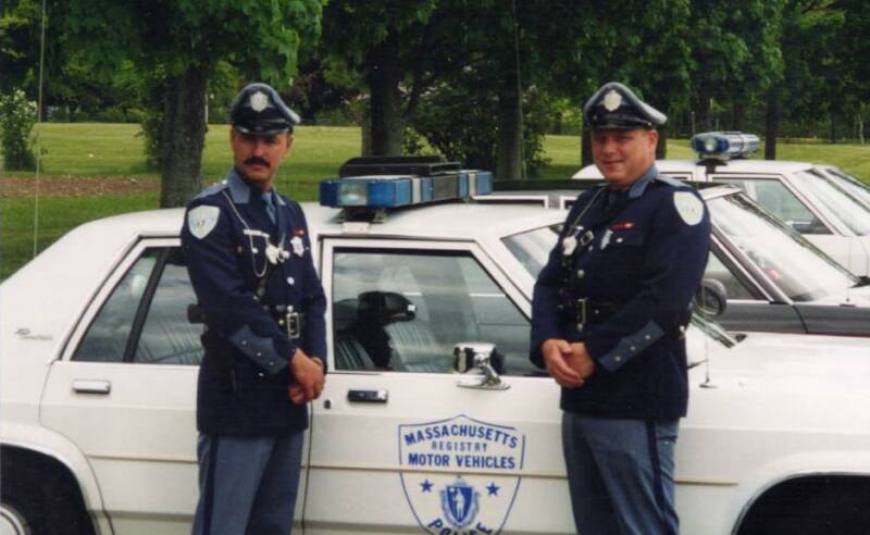 Side view of a 1991 Ford Crown Victoria LTD police car with two officers