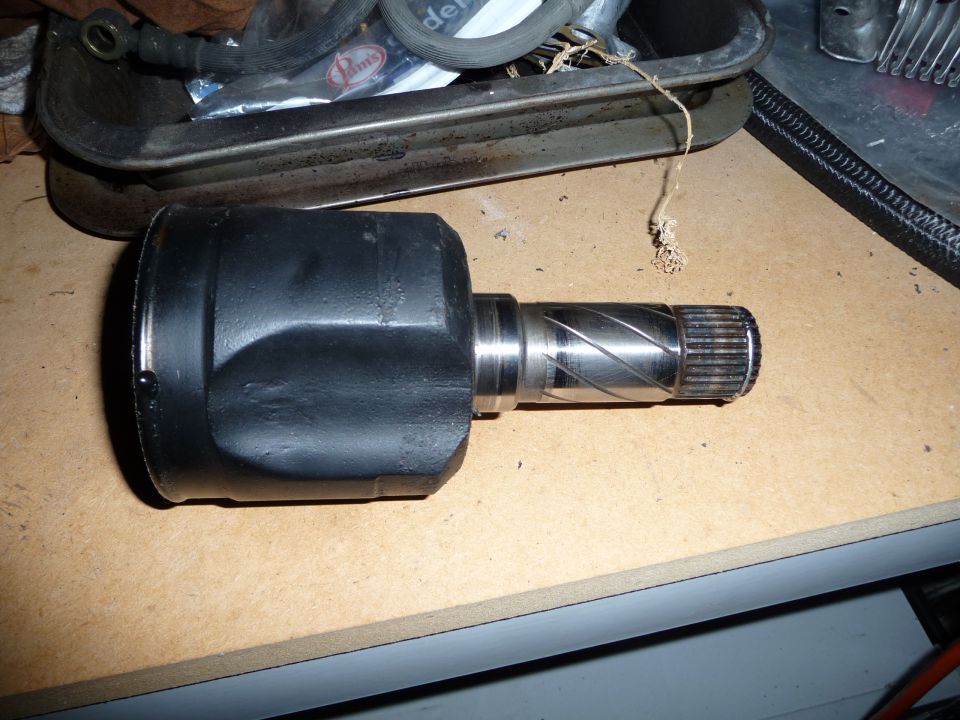 Close-up of a CV axle joint with splines on the shaft
