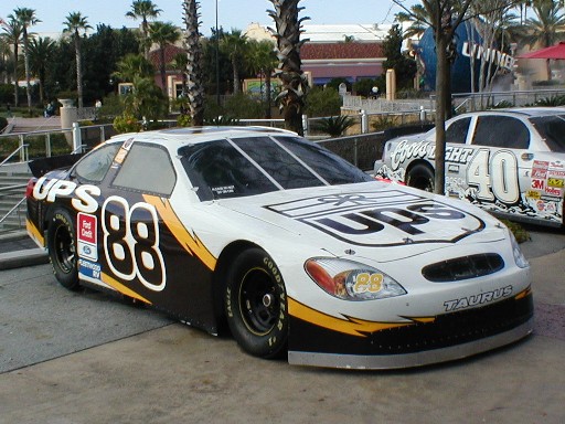 White and black UPS race car with number 88, parked outdoors