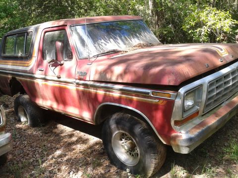 1978 Ford Bronco - This 1978 Ford Bronco shows significant rust and wear, parked in an outdoor setting.