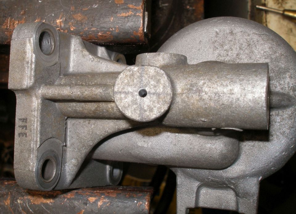 Metal part with FFE marking held in a vise