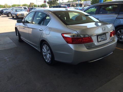 2014 Honda Accord - This silver sedan has a license plate frame from Honda of Seattle, indicating it is likely a Honda Accord.