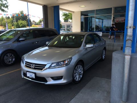 2014 Honda Accord - A silver sedan is parked in front of a dealership with another vehicle to its left.