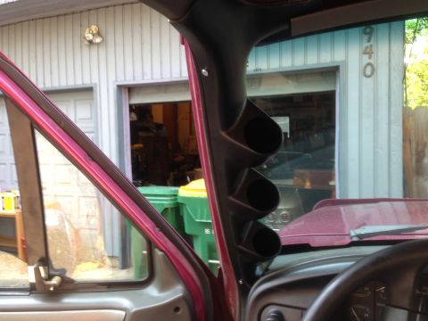 1992 Ford F-150 - A custom gauge pillar is installed inside a vehicle, with a garage visible through the windshield.