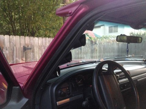 1992 Ford F-150 - Aftermarket gauges are mounted on the A-pillar inside the truck's cabin.