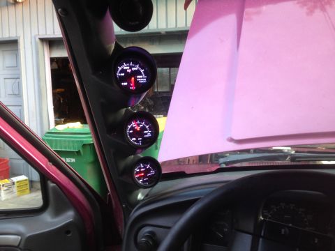1992 Ford F-150 - Aftermarket gauges are mounted on the A-pillar inside a vehicle with its hood open.