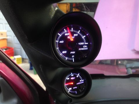 1992 Ford F-150 - Aftermarket gauges installed on a vehicle's gauge pillar, showing oil pressure and boost readings.