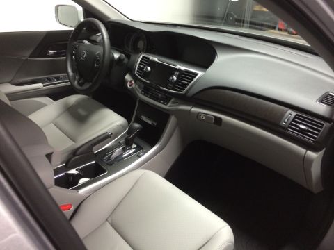 2014 Honda Accord - The interior of a car shows light gray leather seats and a modern dashboard with wood trim accents.