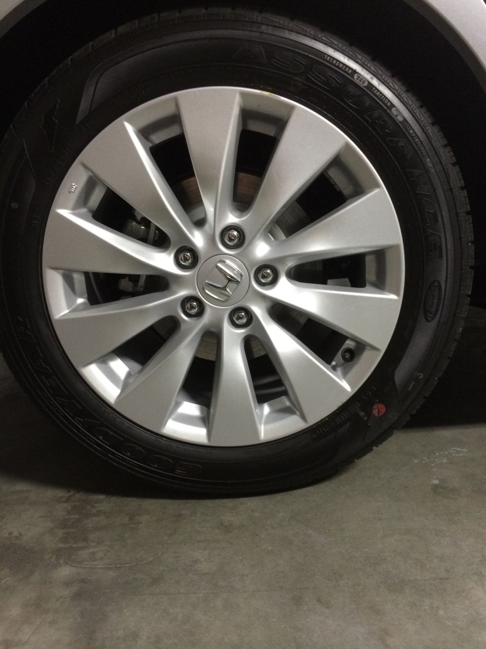 Silver Honda alloy wheel with 10 spokes and a Honda logo in the center, mounted on a black tire. The wheel is clean and appears to be in good condition