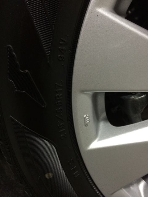 2014 Honda Accord - A close-up view of a silver alloy wheel and tire, showing the tire size 215/55R17.