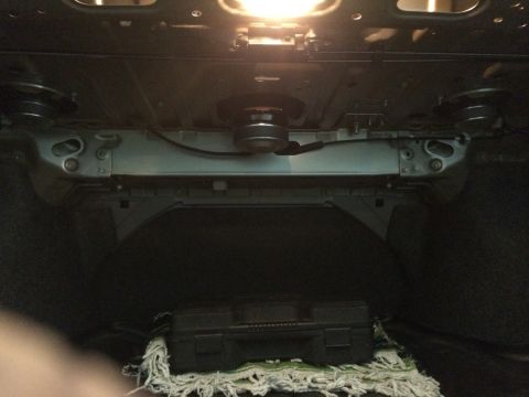 2014 Honda Accord - Underside view of a car's trunk, revealing structural elements and a black toolbox.
