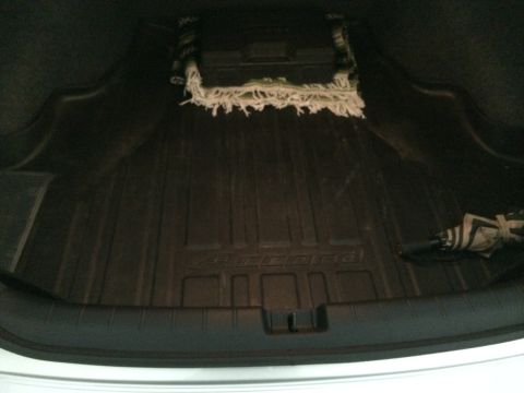 2014 Honda Accord - The trunk of a 2014 Honda Accord features a custom rubber mat and a folded umbrella.