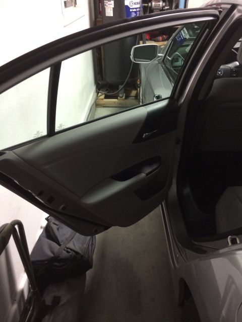 2014 Honda Accord - The interior door panel and open door of a car are visible in this image.