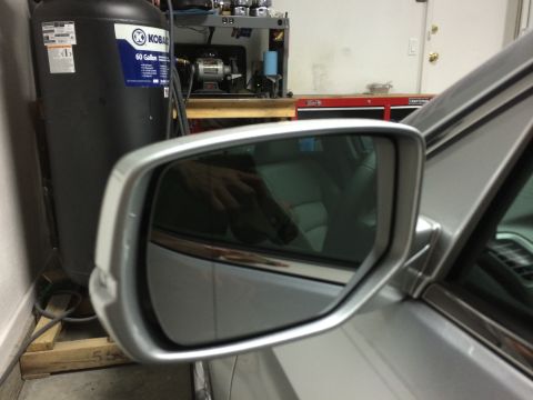 2014 Honda Accord - A close-up view of a car's side mirror, showing a reflection of the interior and a hand.