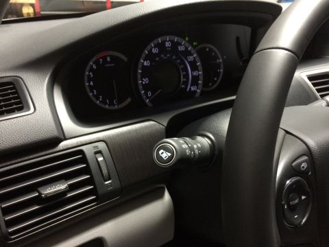 2014 Honda Accord - The interior of a 2014 Honda Accord is captured, highlighting the dashboard instrumentation and steering wheel.