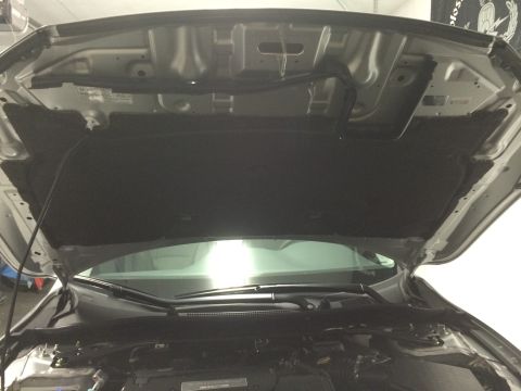 2014 Honda Accord - The underside of a car's hood is shown, revealing the engine compartment and sound dampening material.