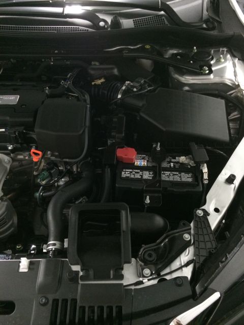 2014 Honda Accord - The engine bay of a vehicle, the battery and air intake system.