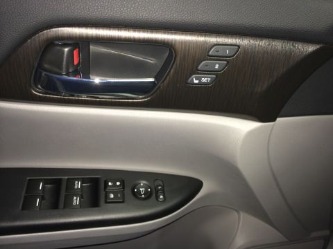 2014 Honda Accord - Close-up of a car's interior door panel, showing the door handle, window controls, and mirror adjustment buttons.