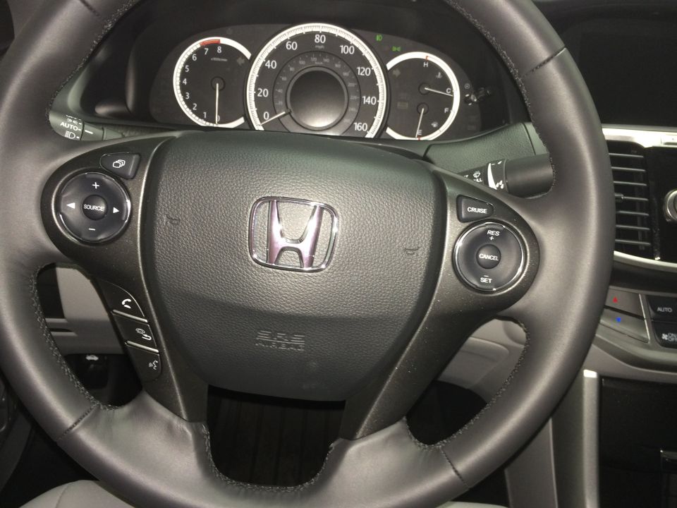 Interior dashboard and steering wheel of a 2014 Honda Accord