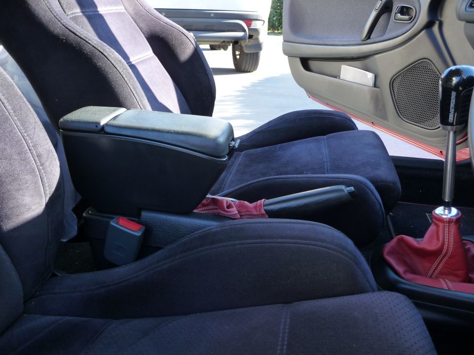 Interior view of a 1993 Mazda MX-3 showing front seats, armrest, and gear shifter