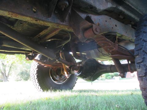 1979 Ford Bronco - Undercarriage view of a vehicle, focusing on the rear axle and suspension components.