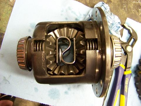 1999 Mercury Grand Marquis - Close-up of a differential assembly, showing internal gears and bearings, with tools nearby.