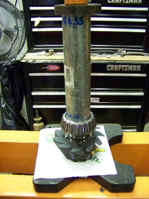 1999 Mercury Grand Marquis - Differential gear and bearing being pressed together in a workshop setting.