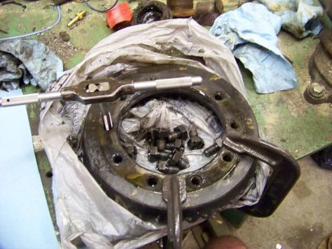 1999 Mercury Grand Marquis - A differential part is shown with a tap and die tool and a pile of bolts, suggesting a repair or rebuild process.