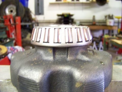1999 Mercury Grand Marquis - Close-up of a tapered roller bearing atop a differential housing, likely in a workshop.