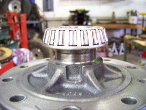 1999 Mercury Grand Marquis - A close-up view of a differential bearing assembly, likely undergoing maintenance or repair in a garage setting.