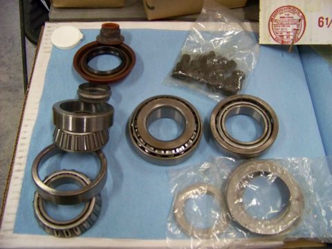 1999 Mercury Grand Marquis - Various automotive parts, including bearings and seals, are arranged on a surface, possibly for a differential rebuild.