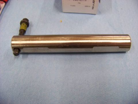 1999 Mercury Grand Marquis - A metal part, possibly a shaft or pin, with a bolt attached, is shown on a blue cloth surface.