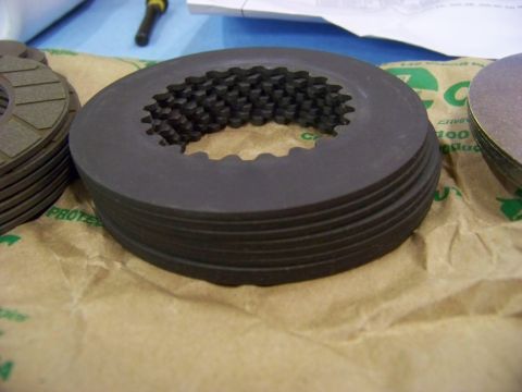 1999 Mercury Grand Marquis - A stack of clutch plates, likely for a vehicle's transmission, are shown on brown paper packaging.