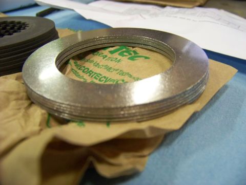 1999 Mercury Grand Marquis - Clutch plates are shown on brown paper with visible text from packaging.