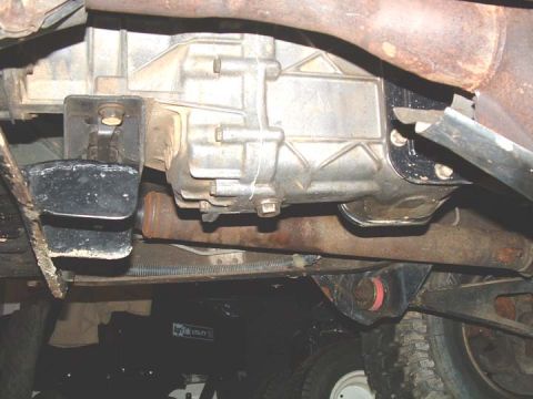 1994 Ford Bronco - Underside view of a vehicle's transmission and exhaust system, showing various mechanical components and some rust.