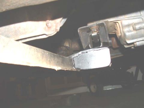1994 Ford Bronco - Close-up view of a cracked engine mount, likely part of a transmission swap.