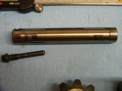 1999 Mercury Grand Marquis - Metal shaft and bolt shown with measuring tools, likely for a mechanical repair.