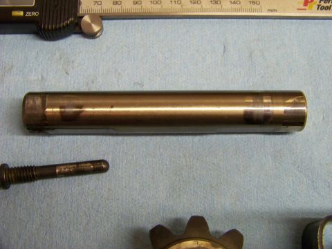 1999 Mercury Grand Marquis - Close-up of a metal cylinder and bolt, likely automotive parts, with measuring tools.