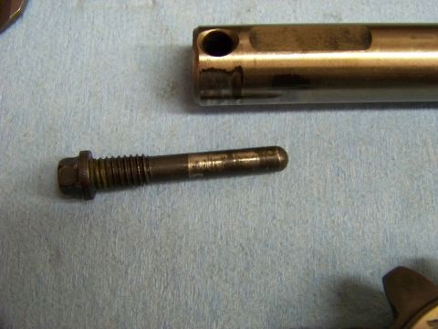 1999 Mercury Grand Marquis - Close-up of automotive components, including a bolt and a metal rod, laid out on a blue cloth.