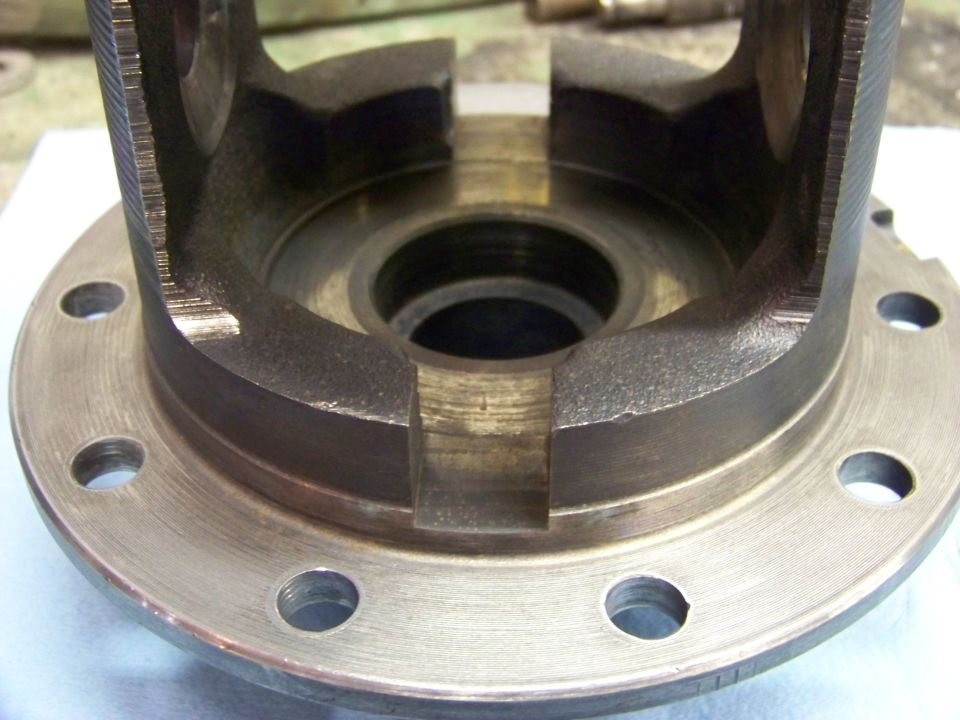 Close-up of a differential carrier housing with bolt holes around the flange