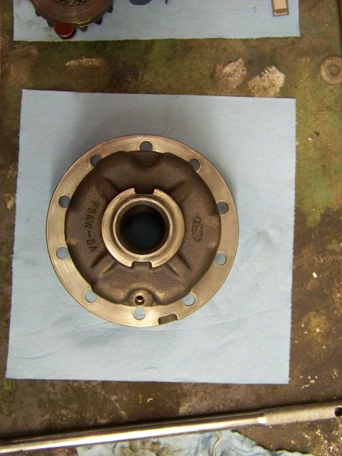 1999 Mercury Grand Marquis - A transmission oil pump housing sits on a blue paper towel, with other parts in the background.