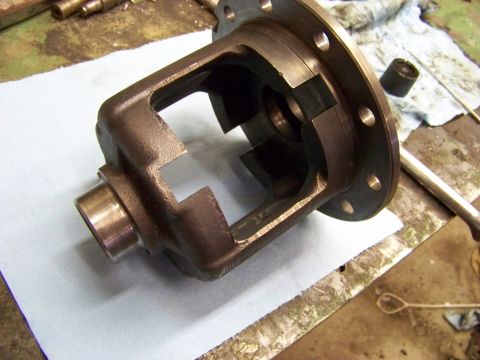 1999 Mercury Grand Marquis - A close-up view of a differential case, a component of a vehicle's drivetrain, resting on a workbench.