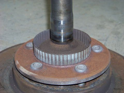1999 Mercury Grand Marquis - Close-up of a wheel hub assembly an ABS tone ring and a splined shaft, likely for a differential rebuild.