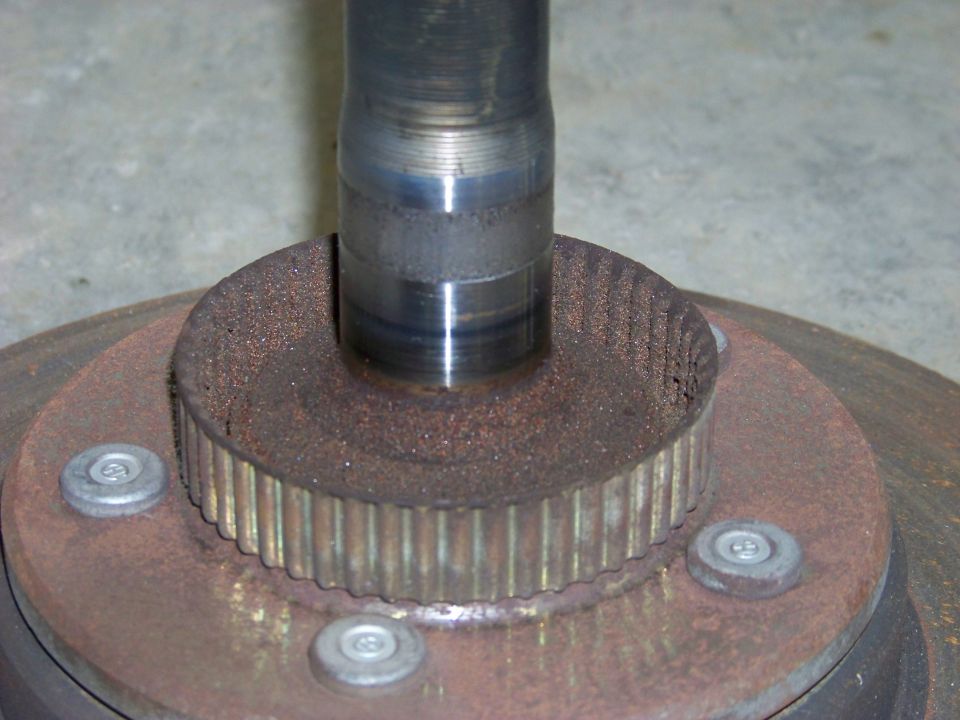 Close-up of a rusted wheel hub with splines and mounting bolts