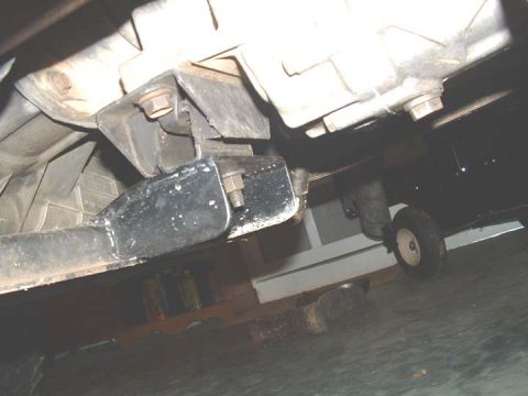 1994 Ford Bronco - Close-up of vehicle undercarriage, showing transmission and exhaust parts.