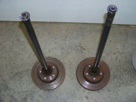 1999 Mercury Grand Marquis - Axles with brake rotors are shown, likely for a differential rebuild.