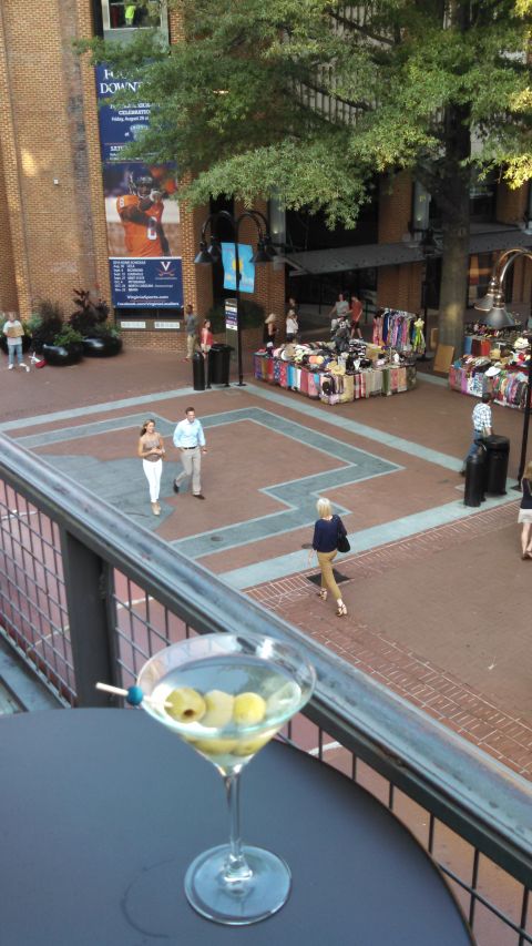 1971 Ford Ranchero - A martini with olives sits in the foreground, overlooking a bustling outdoor market scene with shoppers and vendors.