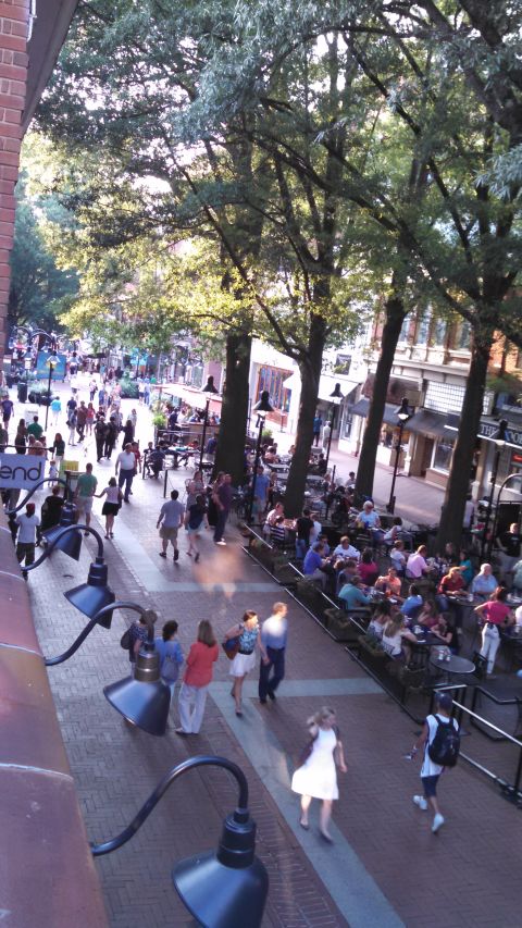1971 Ford Ranchero - A busy street scene with pedestrians and outdoor dining under trees.