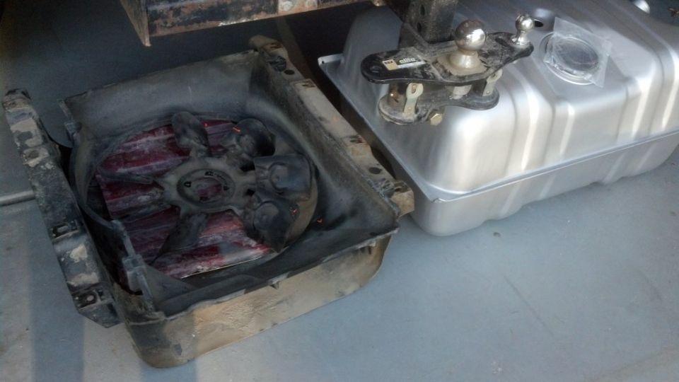 Radiator fan shroud and silver fuel tank with hitch receiver