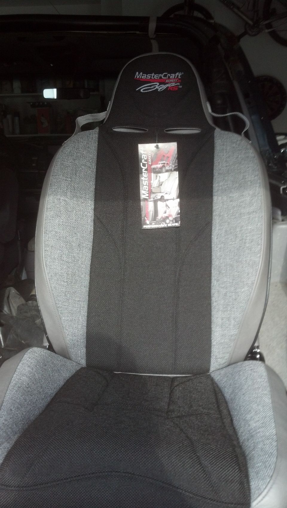 Gray and black fabric car seat with MasterCraft branding on headrest